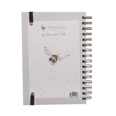 A bumblebee taking flight from flowers on a notebook